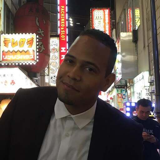 Eduardo Almonte on a neon street in Tokyo.